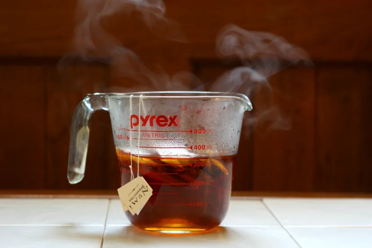 pyrex with hot steeping tea - How to Dye Your Hair with Henna and Tea