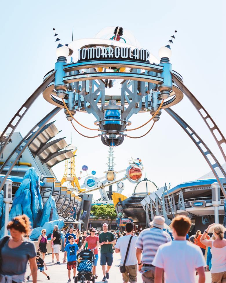 social distancing not working in U.S. due to ideology and individualism - American Culture is a Problem - image of the Tomorrowland arch at Disney