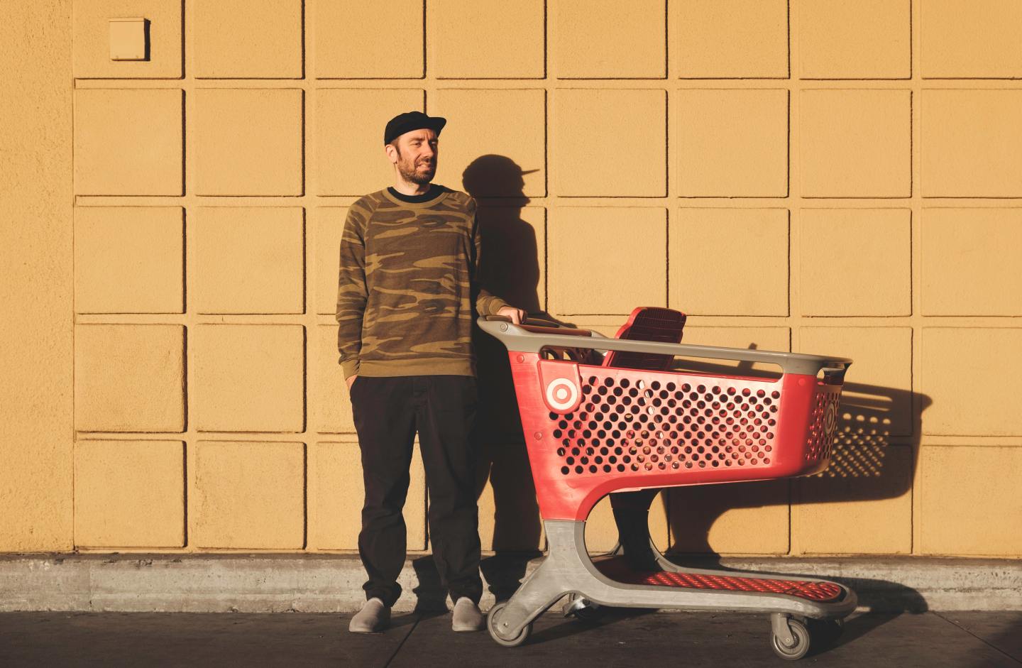 picture of man with Target grocery cart - article on sustainability initiatives at big box stores