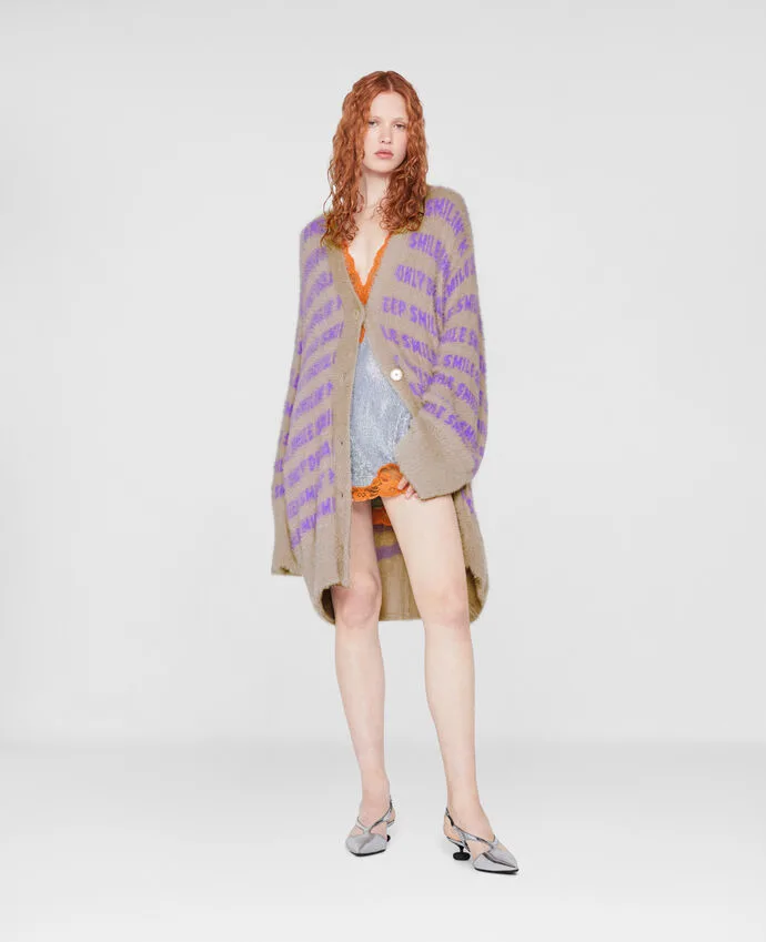 woman with red hair poses in long cardigan with lavender text - Sustainable Brands That Aren't Boring