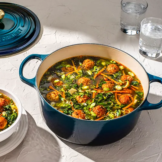 Le Creuset PFAS-free enameled cast iron cookware with soup inside - PFAS Free Nontoxic Cookware