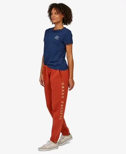 woman wears orange sweatpants with vertical text - Sustainable Y2K Fashion that lets you embrace the nostalgia, have fun, and all without causing further harm to people or planet.